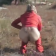 A woman wearing a mask pees & poops while squatting in the grass. Then she pees by the front of a car.